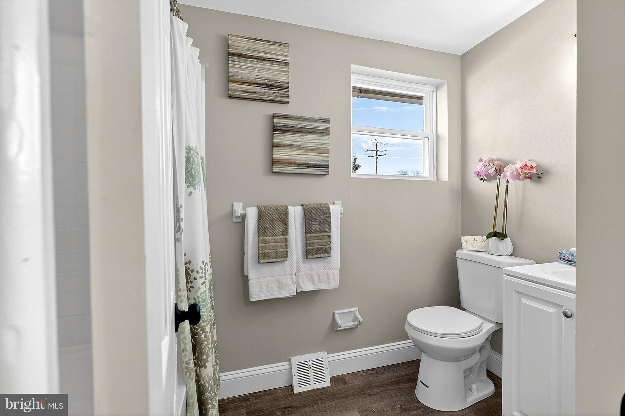 3901 Elson Road Brookhaven, PA 19015 - Photo 33 of 47 a bathroom with a toilet sink and mirror