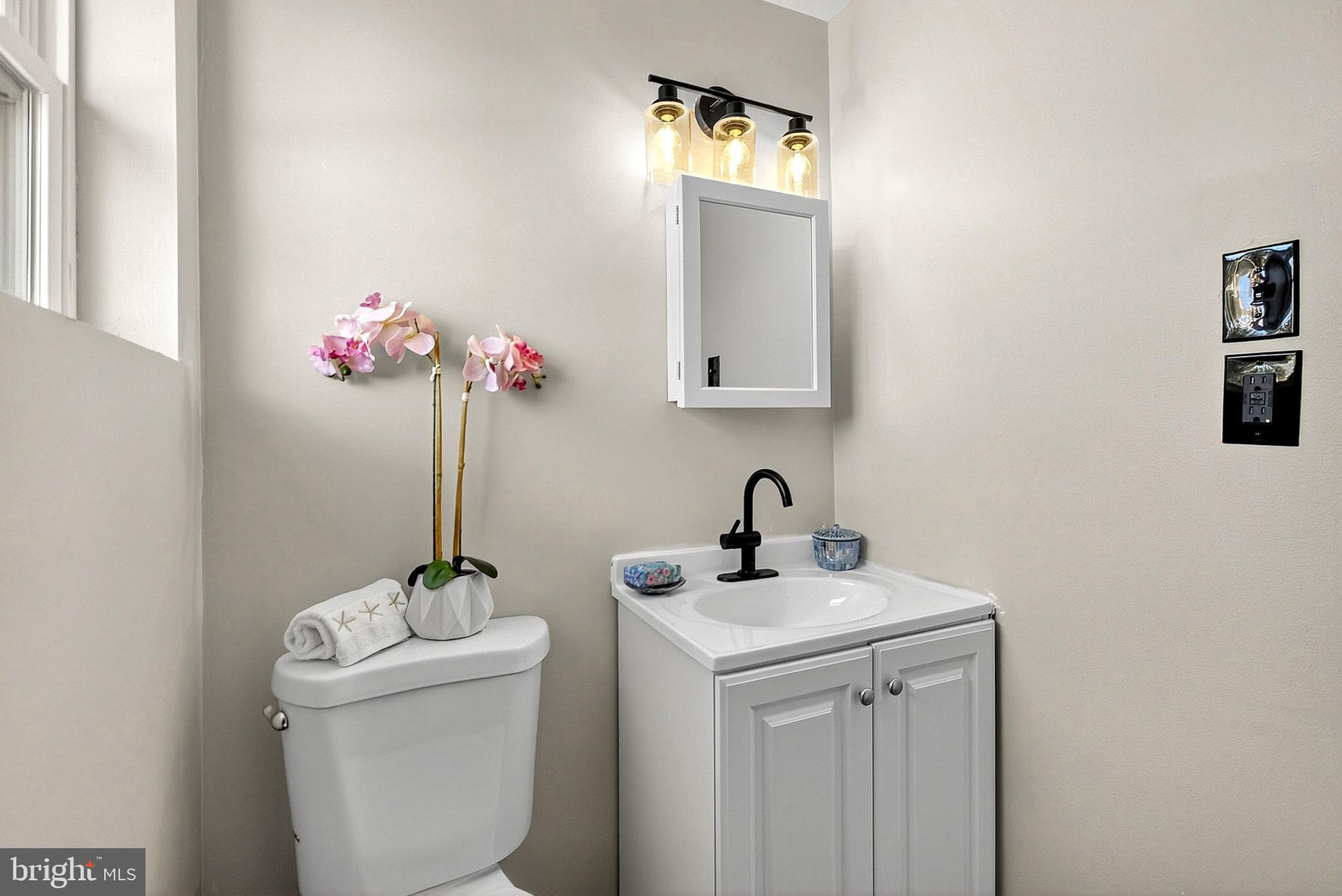 3901 Elson Road Brookhaven, PA 19015 - Photo 34 of 47 a bathroom with a toilet sink and mirror