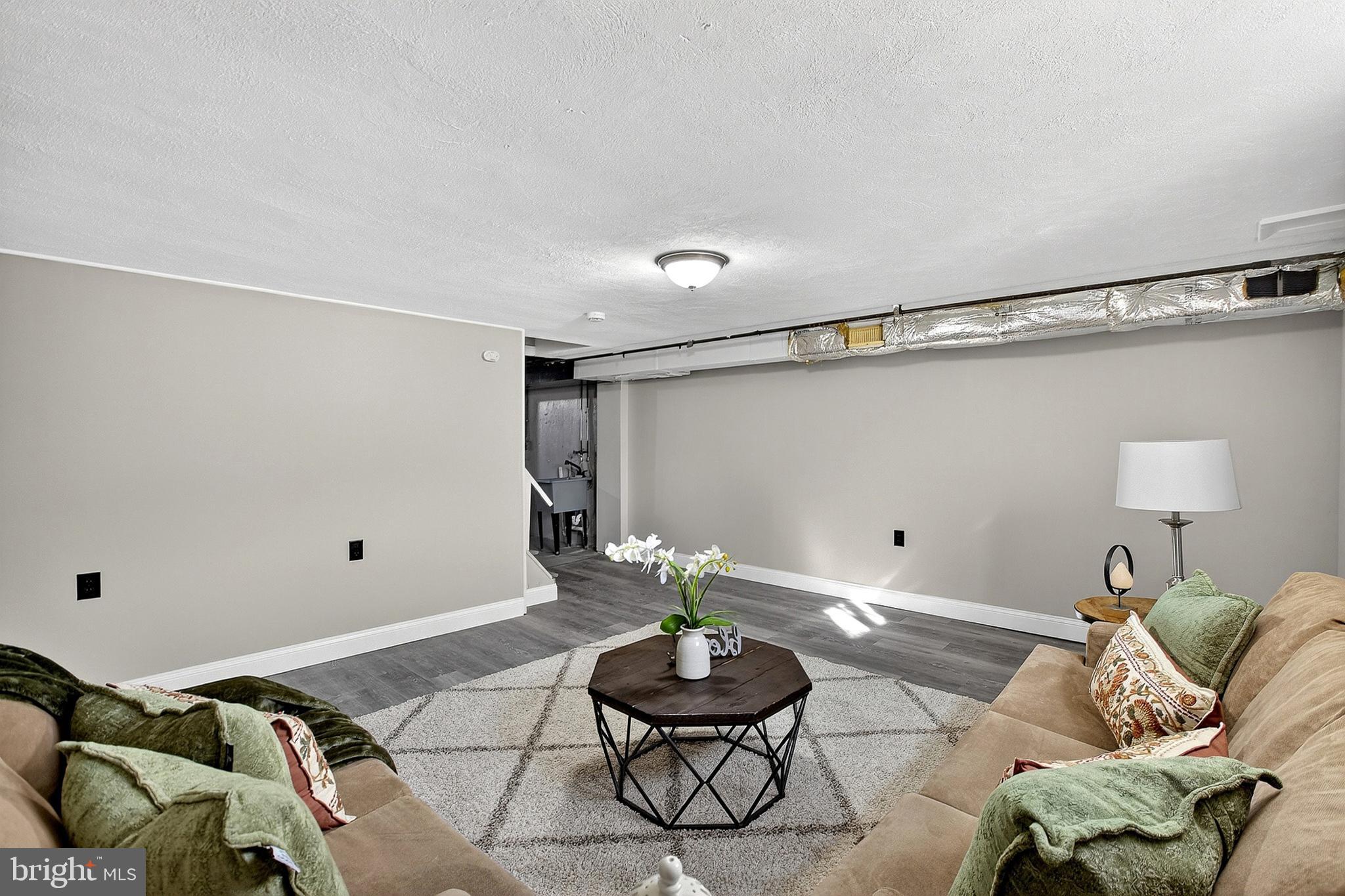 3901 Elson Road Brookhaven, PA 19015 - Photo 39 of 47 a living room with furniture and a potted plant