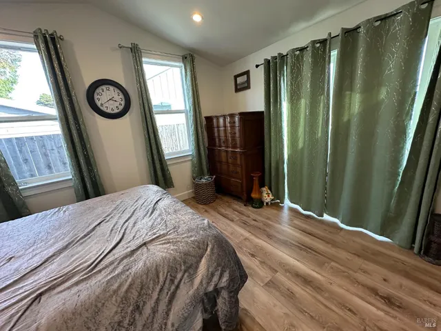 a bedroom with a bed and wall painting