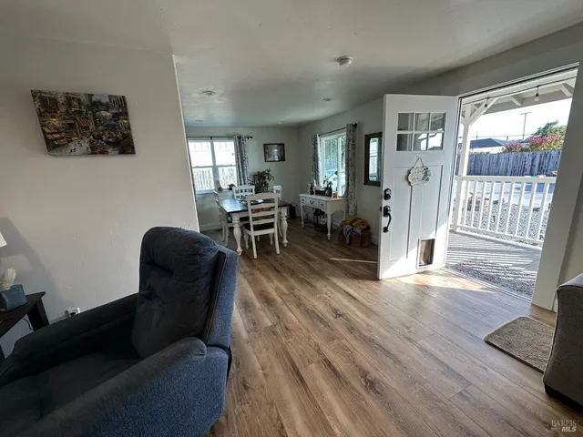 a view of a dining room with furniture window and wooden floor