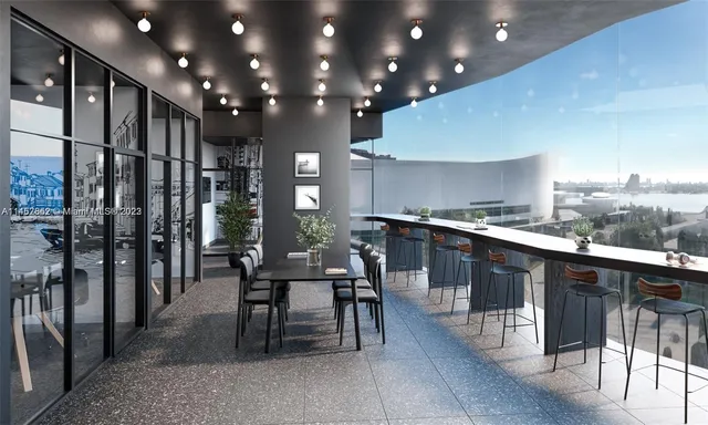 a kitchen with stainless steel appliances kitchen island granite countertop a table chairs and view living room