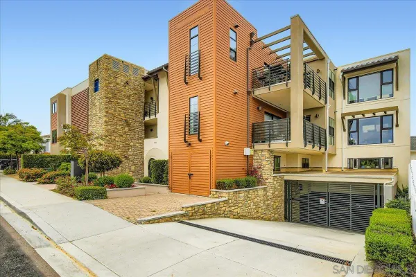 a front view of a residential apartment building with a yard