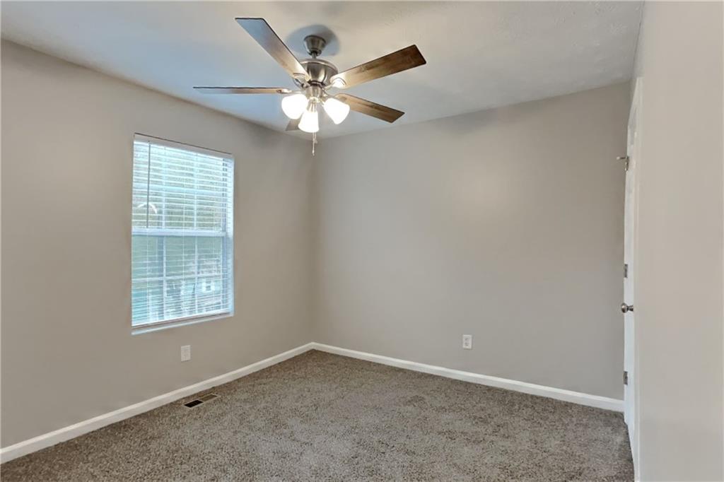 5105 North Bridges Drive Alpharetta, GA 30022 - Photo 13 of 21 an empty room with a window and a fan