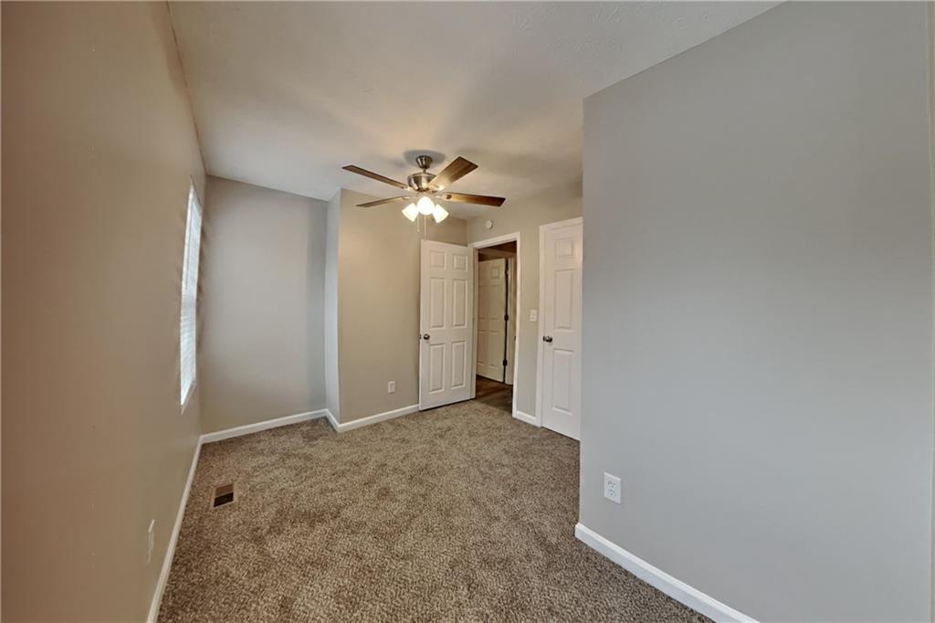 5105 North Bridges Drive Alpharetta, GA 30022 - Photo 14 of 21 an empty room with a chandelier fan and closet