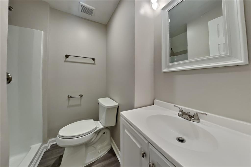 5105 North Bridges Drive Alpharetta, GA 30022 - Photo 16 of 21 a white toilet sitting next to a bathroom sink