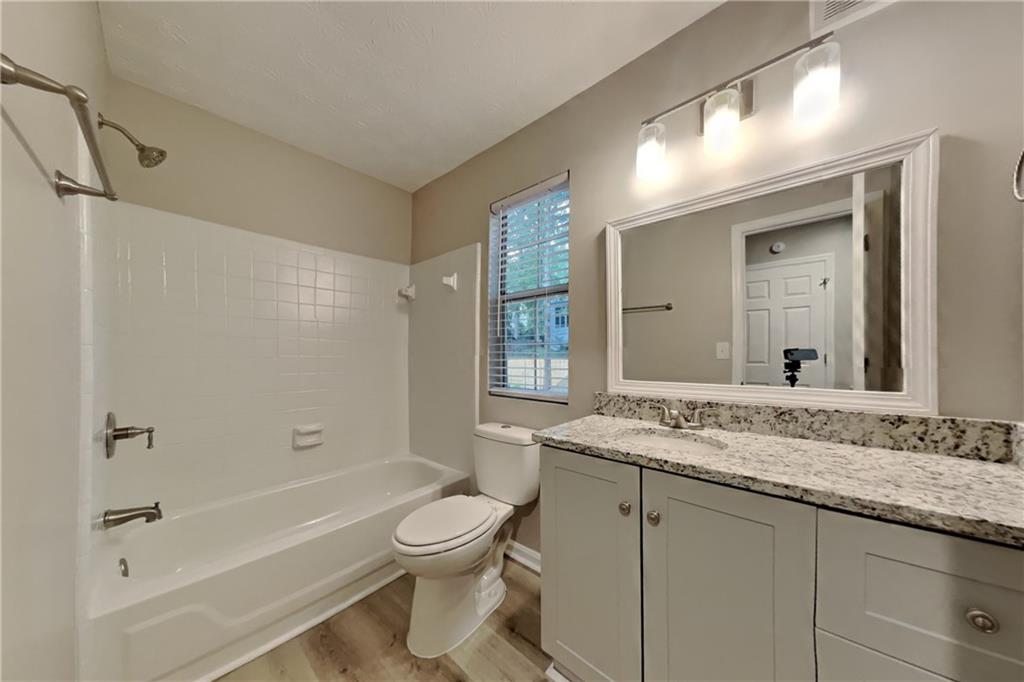 5105 North Bridges Drive Alpharetta, GA 30022 - Photo 17 of 21 a bathroom with a granite countertop sink toilet and shower