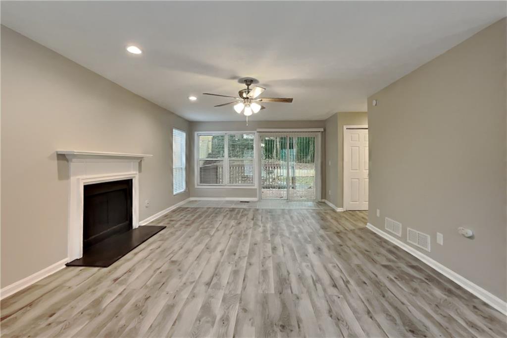 5105 North Bridges Drive Alpharetta, GA 30022 - Photo 2 of 21 a view of an empty room with wooden floor and a fireplace