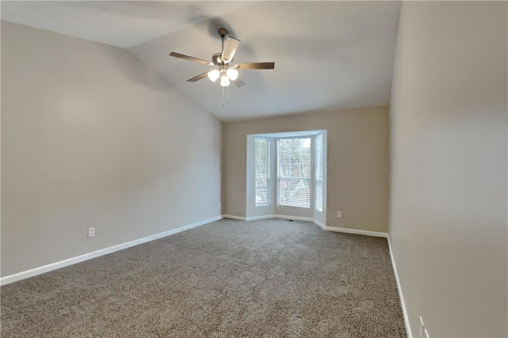 5105 North Bridges Drive Alpharetta, GA 30022 - Photo 7 of 21 a view of an empty room with a chandelier fan