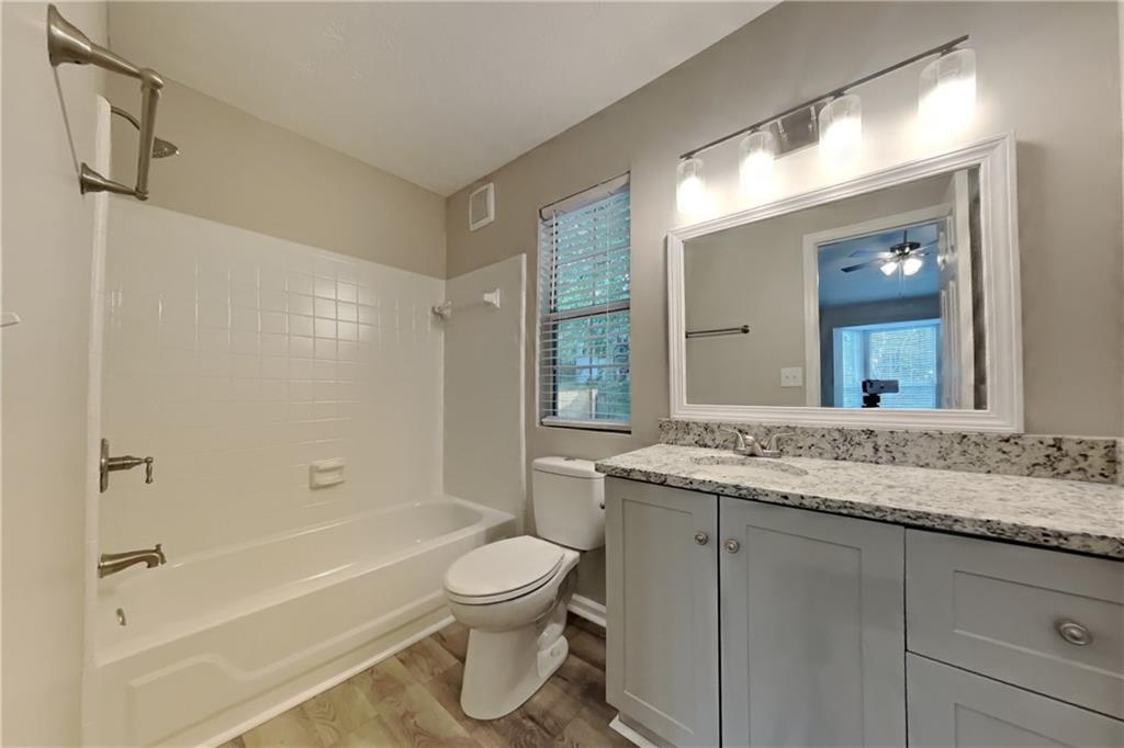 5105 North Bridges Drive Alpharetta, GA 30022 - Photo 9 of 21 a bathroom with a granite countertop sink toilet and shower