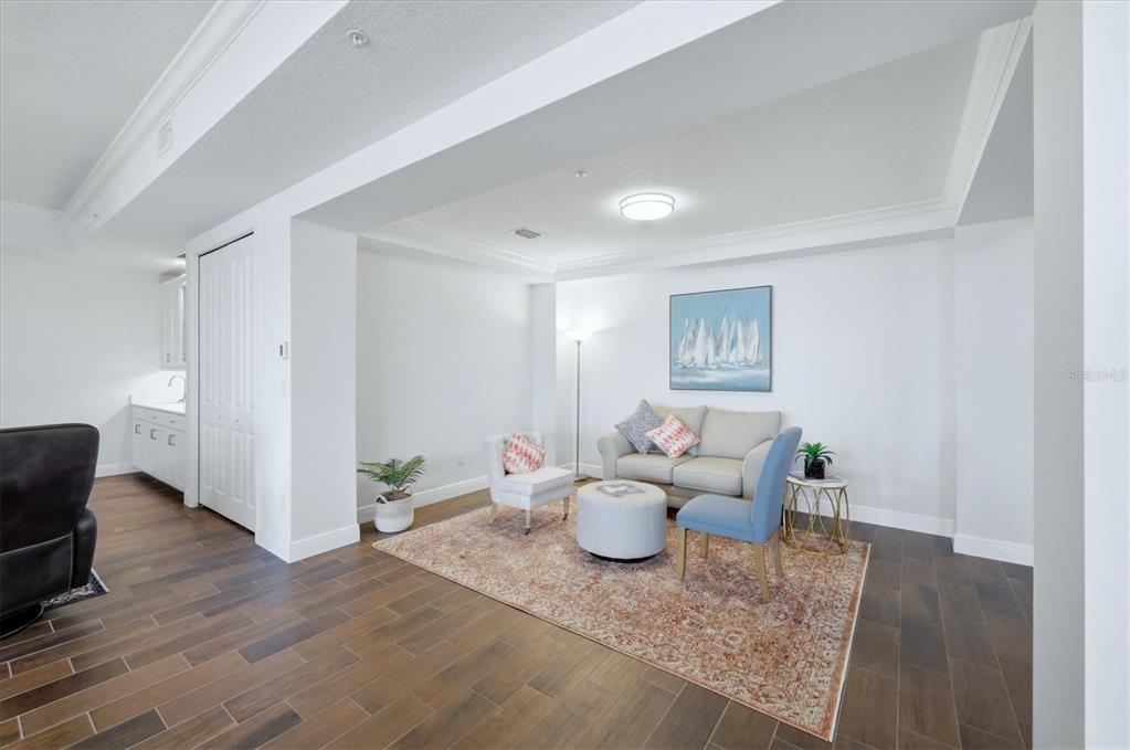 10510 Boardwalk Loop, Unit 602 Lakewood Ranch, FL 34202 - Photo 11 of 77 a living room with furniture and wooden floor