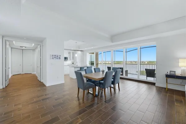 a kitchen that has a sink and chairs