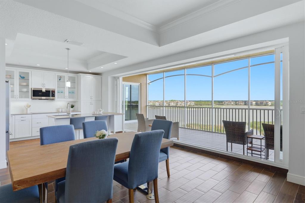 10510 Boardwalk Loop, Unit 602 Lakewood Ranch, FL 34202 - Photo 16 of 77 a view of a dining room with furniture and a window