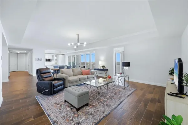 a living room with furniture and a wooden floor