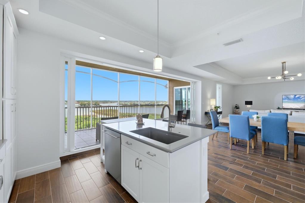 10510 Boardwalk Loop, Unit 602 Lakewood Ranch, FL 34202 - Photo 24 of 77 a kitchen that has a sink and chairs