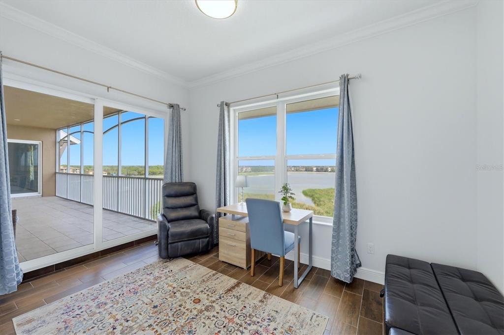 10510 Boardwalk Loop, Unit 602 Lakewood Ranch, FL 34202 - Photo 26 of 77 a living room with furniture and a wooden floor