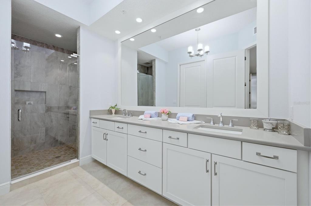 10510 Boardwalk Loop, Unit 602 Lakewood Ranch, FL 34202 - Photo 27 of 77 a bathroom with double sink and a mirror