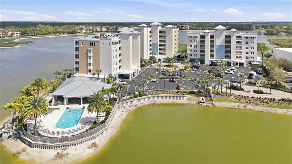 10510 Boardwalk Loop, Unit 602 Lakewood Ranch, FL 34202 - Photo 3 of 77 a view of a swimming pool with a lot of chairs