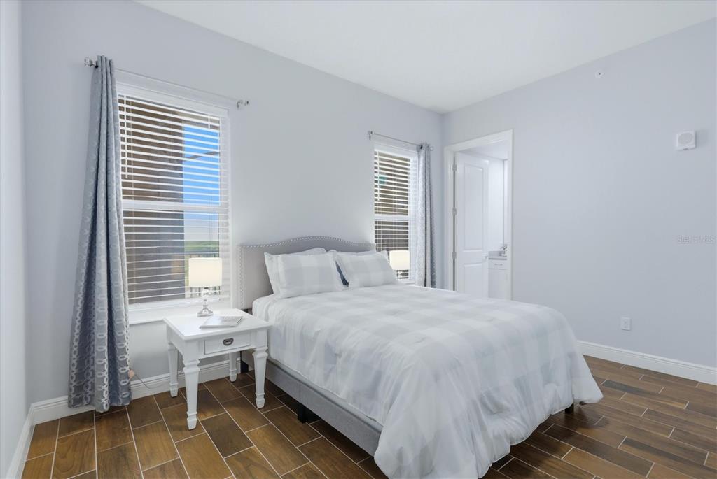 10510 Boardwalk Loop, Unit 602 Lakewood Ranch, FL 34202 - Photo 32 of 77 a bedroom with a bed and a window