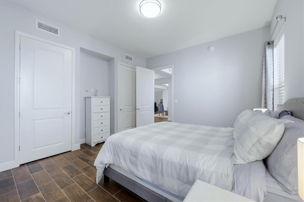 10510 Boardwalk Loop, Unit 602 Lakewood Ranch, FL 34202 - Photo 33 of 77 a bedroom with a bed and a mirror