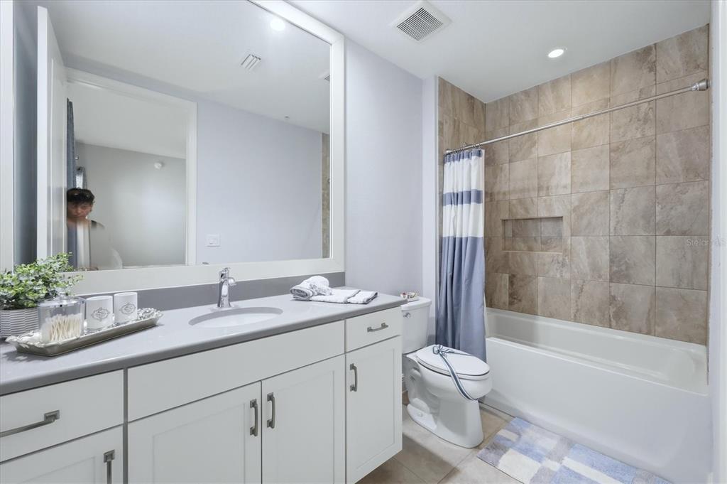 10510 Boardwalk Loop, Unit 602 Lakewood Ranch, FL 34202 - Photo 36 of 77 a bathroom with a granite countertop sink a toilet and bathtub
