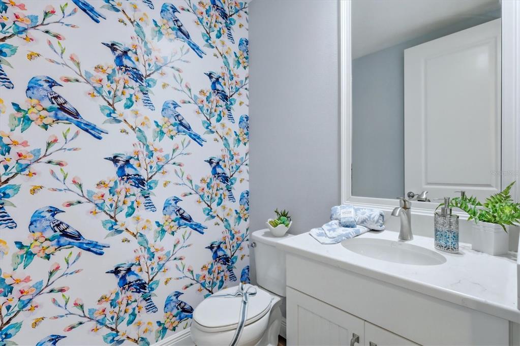 10510 Boardwalk Loop, Unit 602 Lakewood Ranch, FL 34202 - Photo 38 of 77 a bathroom with a sink and mirror with toilet