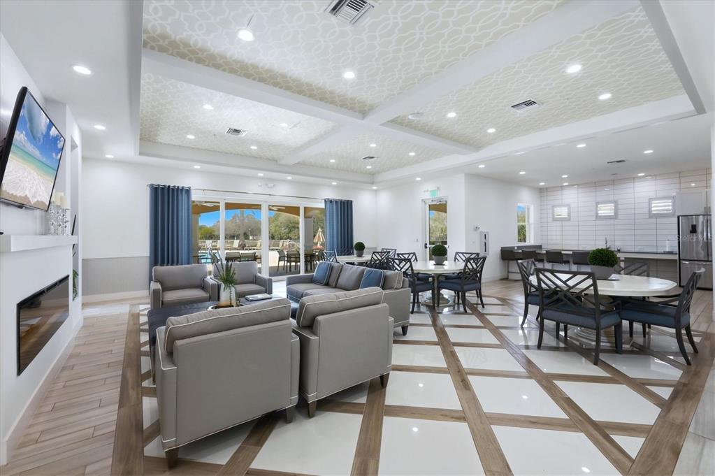 10510 Boardwalk Loop, Unit 602 Lakewood Ranch, FL 34202 - Photo 46 of 77 a living room with furniture a fireplace and a flat screen tv