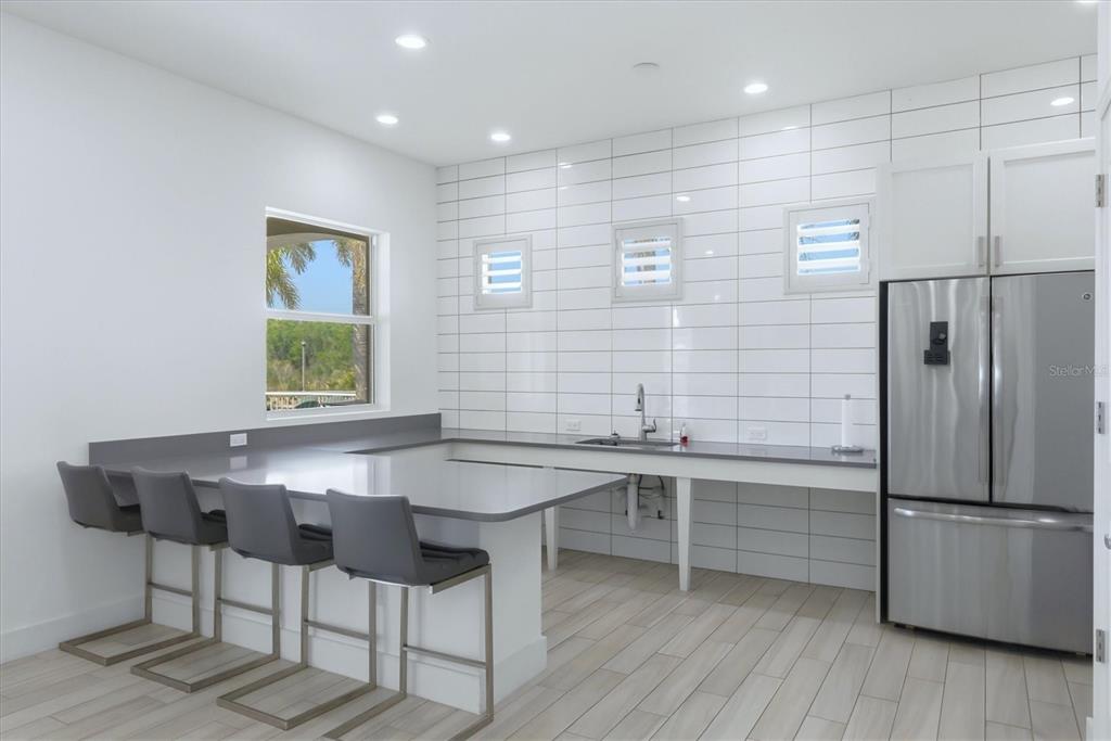 10510 Boardwalk Loop, Unit 602 Lakewood Ranch, FL 34202 - Photo 50 of 77 a kitchen with stainless steel appliances granite countertop a sink and a refrigerator
