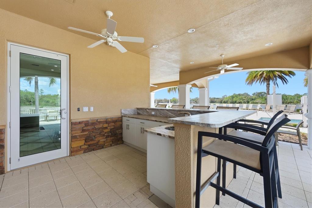 10510 Boardwalk Loop, Unit 602 Lakewood Ranch, FL 34202 - Photo 53 of 77 a kitchen with a table and chairs in it