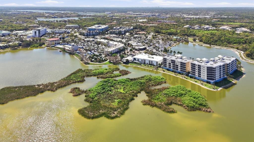 10510 Boardwalk Loop, Unit 602 Lakewood Ranch, FL 34202 - Photo 73 of 77 an aerial view of residential houses with outdoor space and lake view