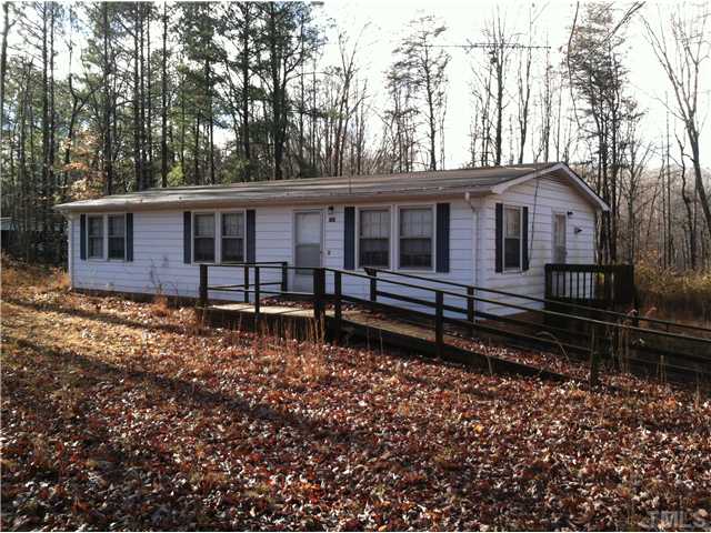 757 Ivey Day Road Roxboro, NC 27574 - Photo 1 of 4 a house with trees in the background