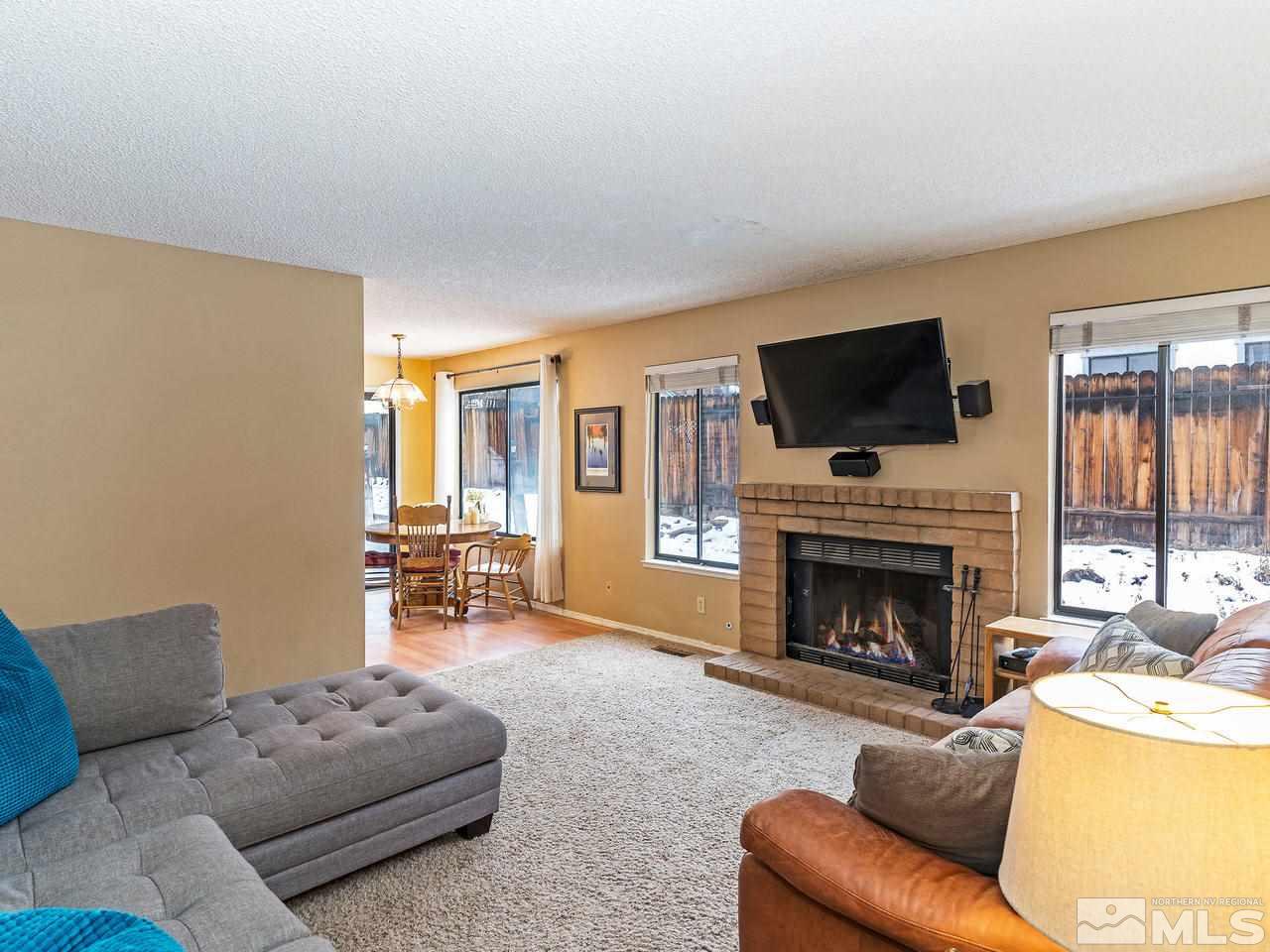 1703 Terrace Heights Lane Reno, NV 89523 - Photo 6 of 13 a living room with furniture a fireplace and a flat screen tv
