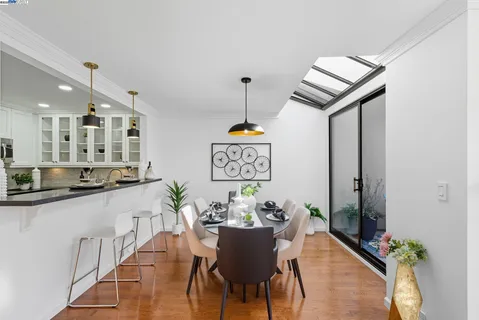 a dining room with furniture and a chandelier
