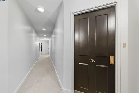 a living room with furniture a fireplace and wall paintings