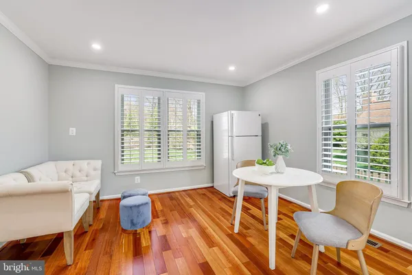 a dining room with furniture wooden floor a chandelier