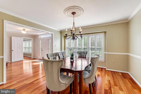 a kitchen with stainless steel appliances granite countertop wooden cabinets a sink and dishwasher with wooden floor