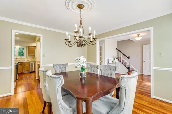 a kitchen with stainless steel appliances granite countertop wooden cabinets a sink and dishwasher with wooden floor