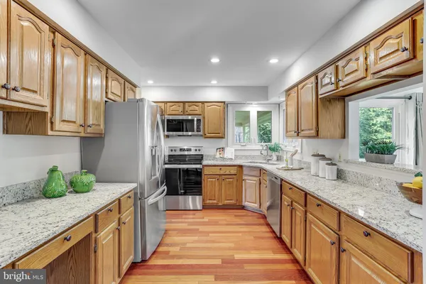 a kitchen with stainless steel appliances granite countertop a stove and a sink