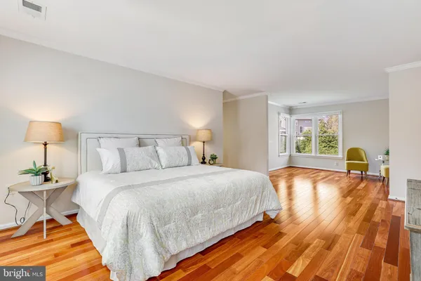 a bed room with a bed and a chair