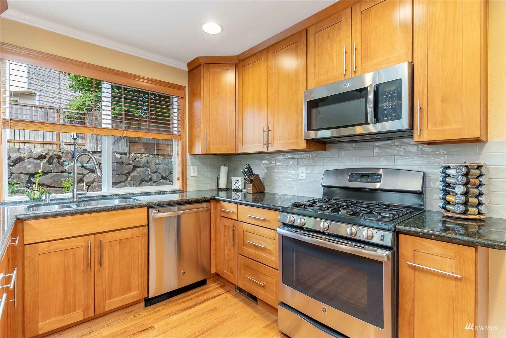 1807 Field Avenue Northeast Renton, WA 98059 - Photo 16 of 38 a kitchen with stainless steel appliances granite countertop a stove a sink and a microwave