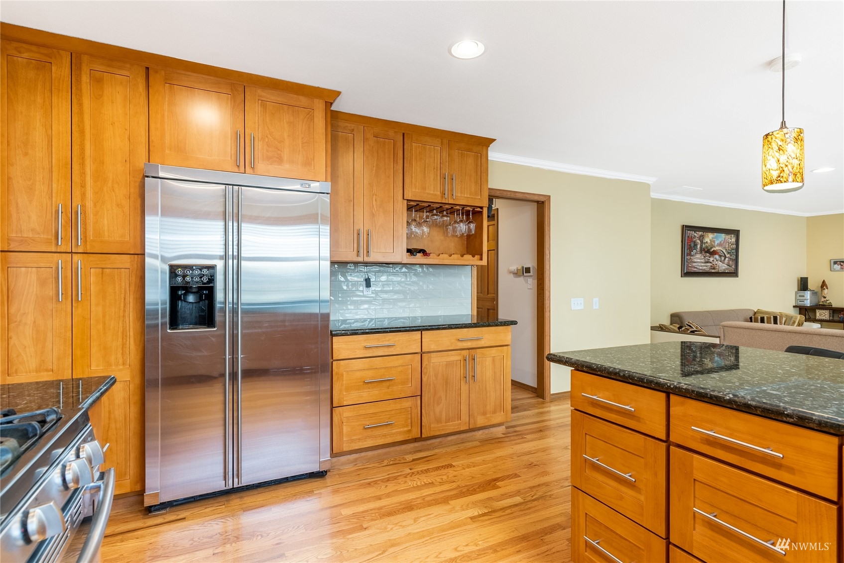 1807 Field Avenue Northeast Renton, WA 98059 - Photo 17 of 38 a kitchen with stainless steel appliances granite countertop a refrigerator a stove and a sink with wooden floor