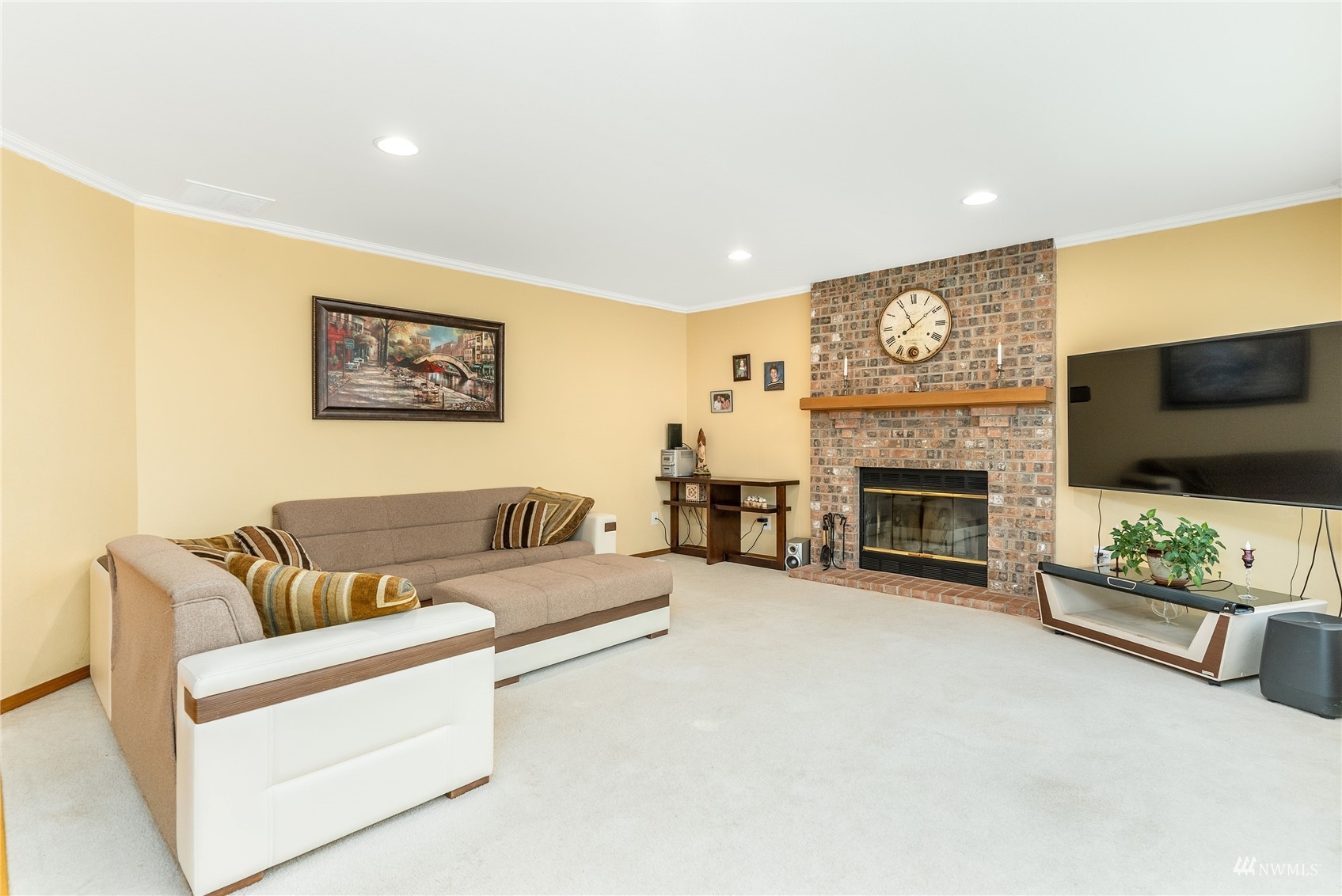 1807 Field Avenue Northeast Renton, WA 98059 - Photo 18 of 38 a living room with furniture a flat screen tv and a fireplace