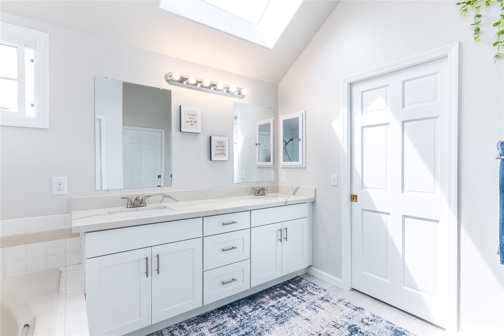 1807 Field Avenue Northeast Renton, WA 98059 - Photo 31 of 38 a spacious bathroom with a double vanity sink a mirror and a