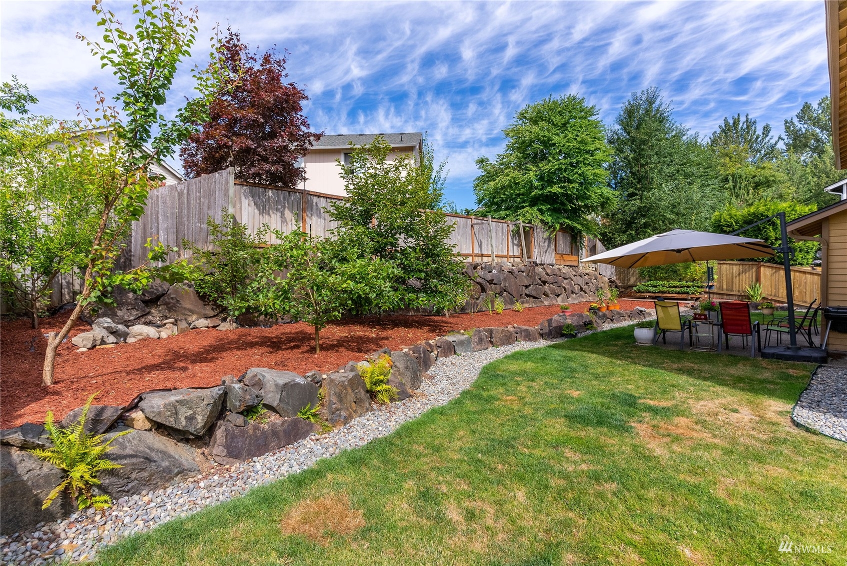 1807 Field Avenue Northeast Renton, WA 98059 - Photo 4 of 38 a view of a garden with large trees