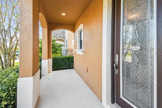 a kitchen with stainless steel appliances kitchen island granite countertop a refrigerator a stove and white cabinets with wooden floor