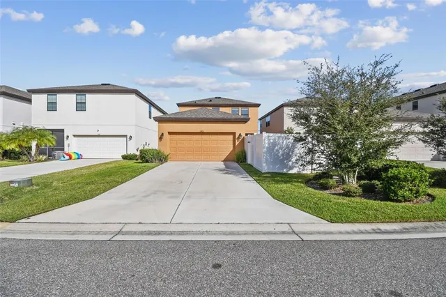 a view of a patio with a table and chairs under an umbrella