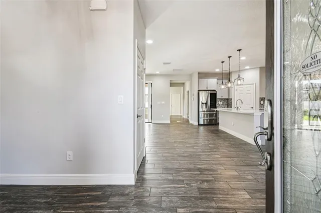 a view of a kitchen with wooden floor and electronic appliances