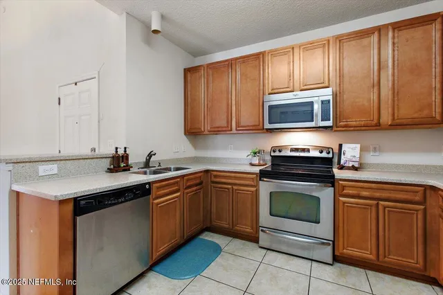 a kitchen with a sink stove and microwave