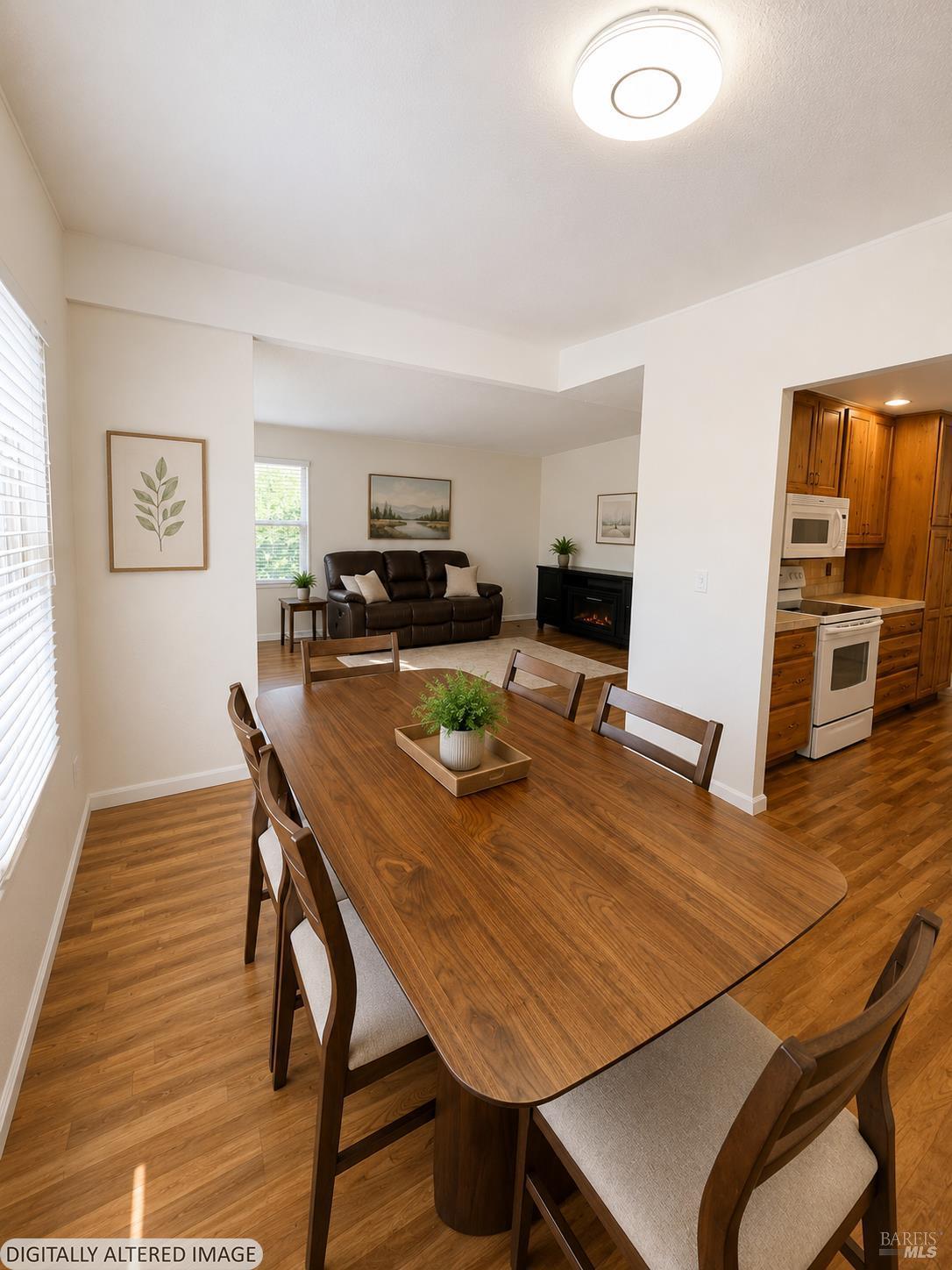 1945 Piner Road, Unit 16 Santa Rosa, CA 95403 - Photo 6 of 18 a view of a dining room with furniture window and wooden floor