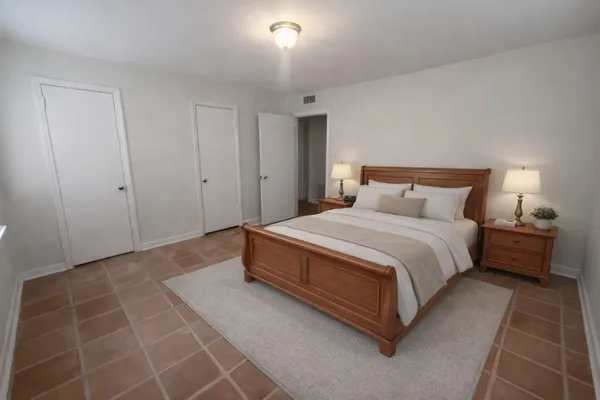 a spacious bedroom with a bed and a shower